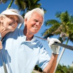 Happy Senior Man & Woman Couple Playing Golf